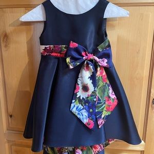 navy blue with flower print detail on the inside and bow toddler dress